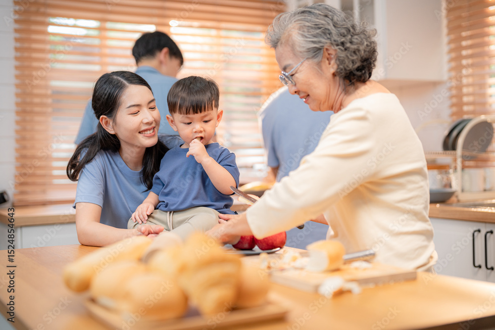 Fototapeta premium Family enjoying cooking together in a bright kitchen with smiles and engagement during a weekend activity