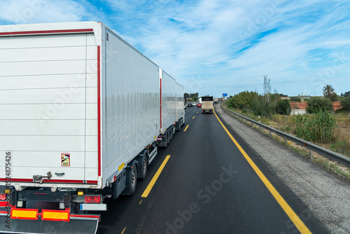 Highway scene with a megatrailer (gigaliner) truck carrying three specialized swap bodies for parcel and groupage logistics.