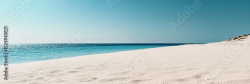 Calm Beach With Fine Sand and Clear Blue Water During Midday Under a Bright Sky