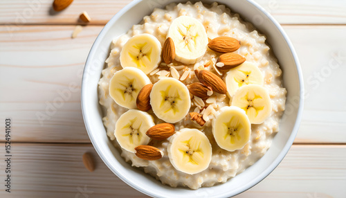 Wallpaper Mural Healthy oatmeal with banana slices and almonds, close-up from above Torontodigital.ca