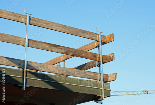 barrier with wooden planks installed on the roof for the protection of workers to avoid falls during the roof repair work