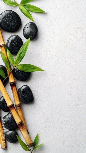 Relaxing Arrangement of Black Stones and Bamboo With Green Leaves on a Light ...