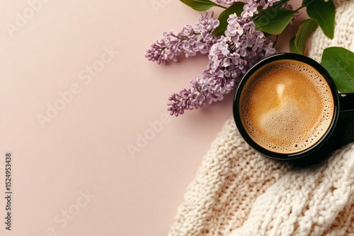 Warm Coffee Cup Beside Lilac Flowers on a Cozy Knitted Blanket During a Seren...