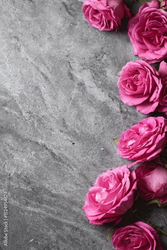 Pink Roses Arranged on Textured Gray Stone Surface for a Beautiful Natural Di...