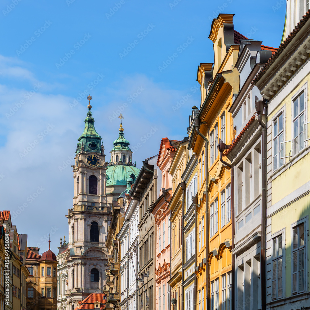 Fototapeta premium The dome and bell tower of the ancient Church of St. Nicholas on Lesser Town Square in Prague on a spring day