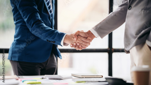 Two men shake hands in a business meeting