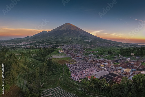 Thousands gather for Eid al-Adha prayer at Garung Field with Mount Sindoro as backdrop, Wonosobo, Central Java, June 6, 2025