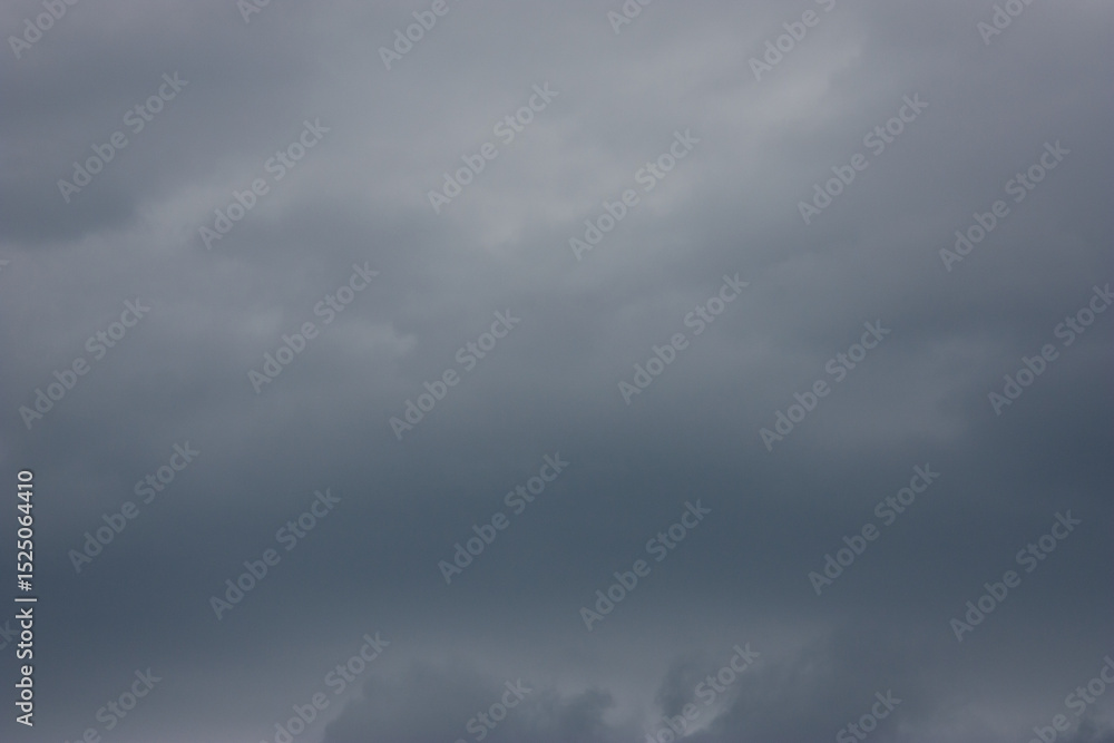 Obraz premium Stormy clouds and rain with dramatic sky above the trees. Rain clouds. Dark cloudy sky before thunderstorm. Stormy cloudy skies. Over head shot of rain clouds. The natural diverse shape of clouds