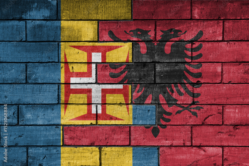 Fototapeta premium colourful painted big national flag of madeira and flag of albania on a massive old brick wall background. concept