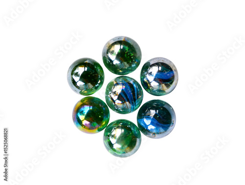 A collection of shiny marbles arranged like flowers on a white background.