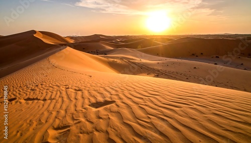 Desert sunset with sand dunes, and footprints.