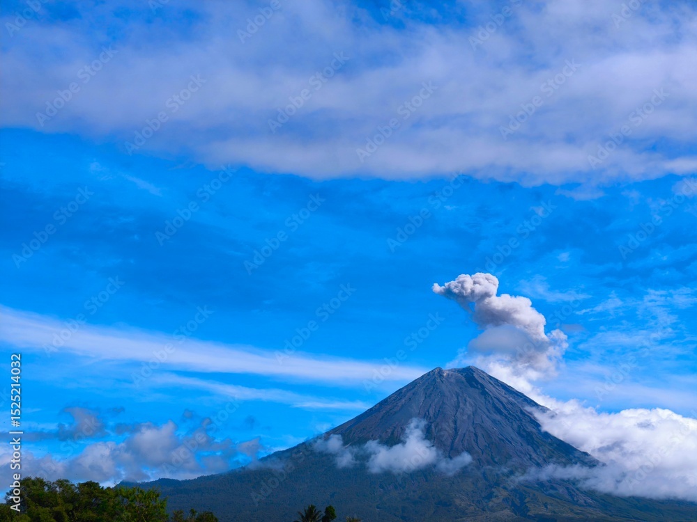 Obraz premium Scenic View of Mount Semeru with Rising Smoke in morning.