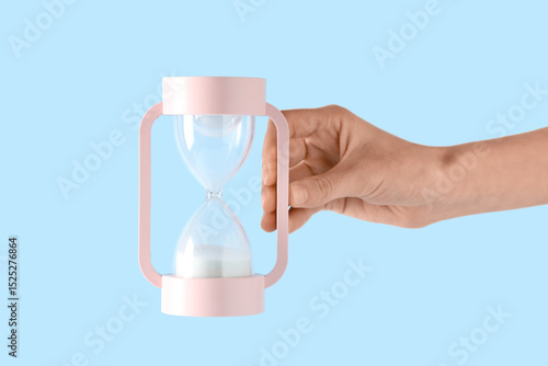 Female hand with white sand...
