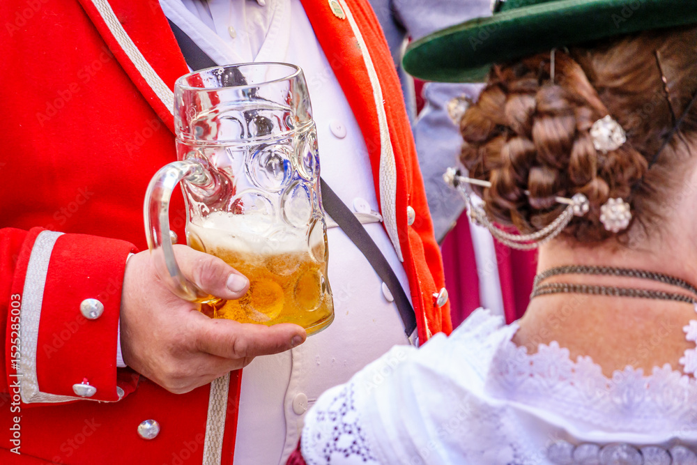 custom made wallpaper toronto digitalTraditional celebration featuring a man in red jacket holding a large beer mug while a woman in elegant attire stands nearby at a cultural festival