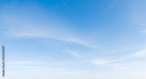 Fototapeta Naklejka Na Ścianę i Meble -  Clear blue sky with wispy clouds creating a tranquil natural atmosphere
