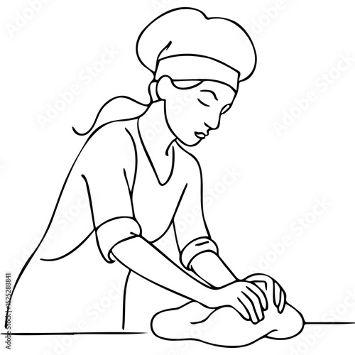 Young baker kneading dough while wearing a headscarf in the kitchen  