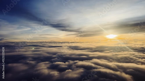 A breathtaking view of the sun rising over a vast sea of clouds, casting warm golden light across the sky and creating a serene, dreamlike atmosphere.