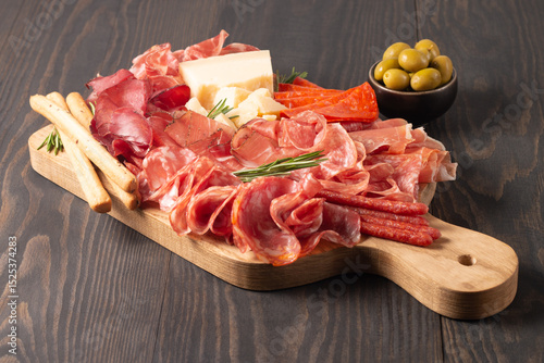 Charcuterie board. Antipasti appetizers of meat platter with salami, prosciutto crudo or jamon and olives.