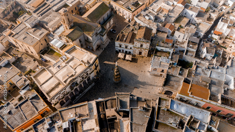 Fototapeta premium Aerial view of the baroque heart of Nardo, Italy, during golden hour. The cathedral and white rooftops glow in warm light, revealing the towns intricate historic layout