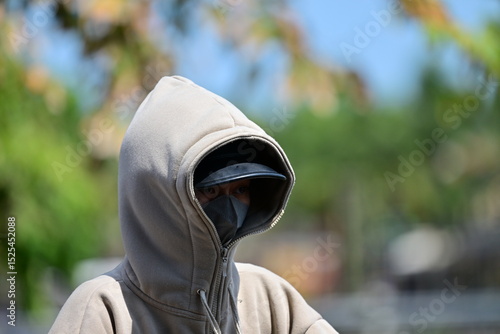A young, completely sun protected woman in Hoi-An-Vietnam on a hot summer day.