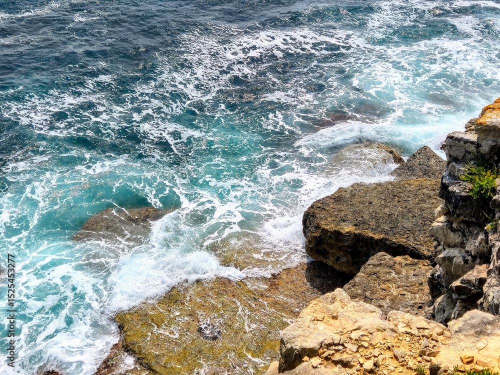 Waves Crashing on Rocky Shoreline – Aerial View of Turquoise Sea Foam and Coastal Texture