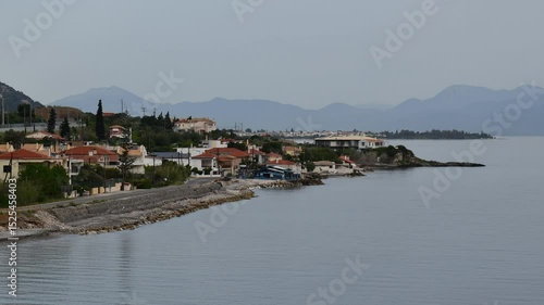 Tranquil beauty of Mavra Litharia coastal village in Greece time lapse landscape. Greek sea coast with small village and traditional Greek houses