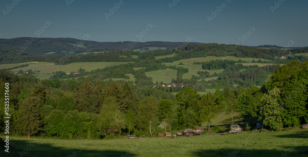 Summer hot morning with green meadows and forests in Sumava mountains Summer hot morning with green meadows and forests in Sumava mountains