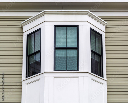 Architectural detail of a black-framed bay window on building exterior in Brighton, Massachusetts, USA
