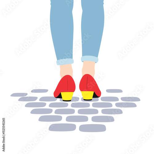 Red high heels worn by woman standing on cobblestone street  