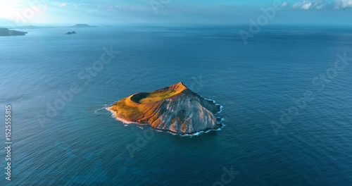 Beautiful bare island surrounded by the Pacific Ocean. Aerial perspective on the Rabbit Island near Oahu, Hawaii, USA.