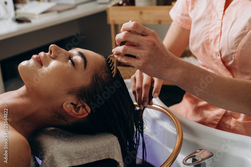 Scalp spa massage using comb tools for relaxation and head‑care treatment