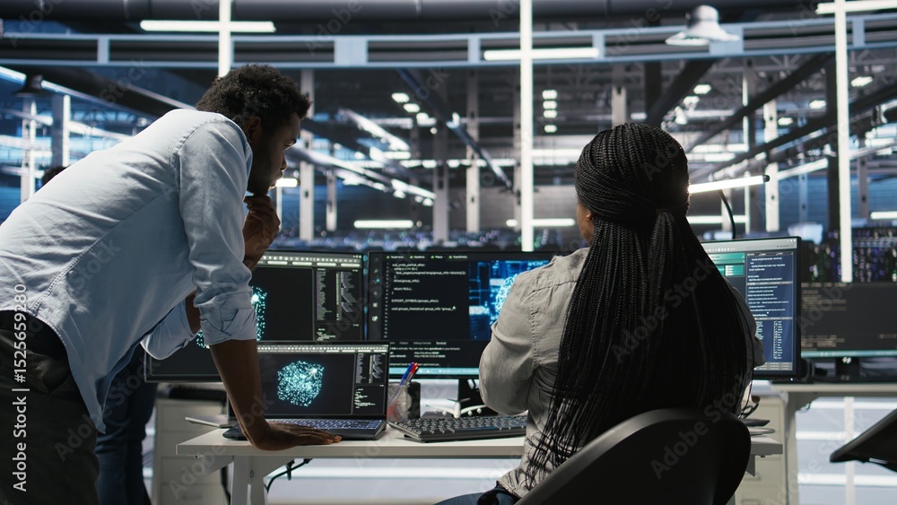Obraz premium Data center manager supervising worker deploying AI solutions optimizing equipment. Server farm supervisor overseeing programmer using artificial intelligence to minimize systems downtime, camera A
