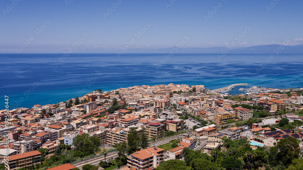 Obraz premium Aerial view of Tropea, a charming town perched on a cliff overlooking the Tyrrhenian Sea in Calabria, Southern Italy, enjoying a sunny summer day
