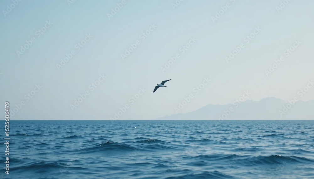 Fototapeta premium Serene Ocean Scene Bird in Flight Over Calm Water with Distant Mountains