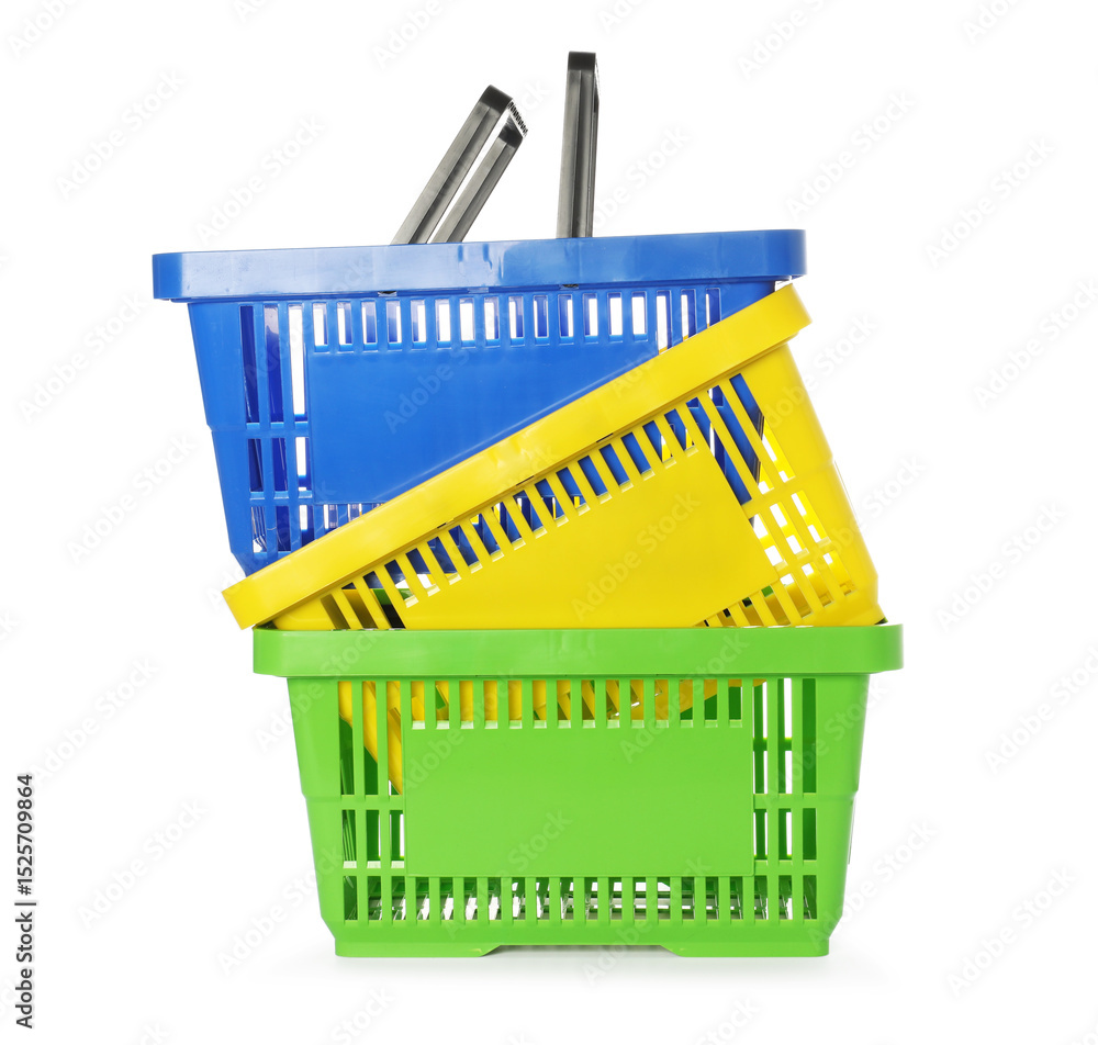 Fototapeta premium Stack of colorful shopping baskets isolated on white