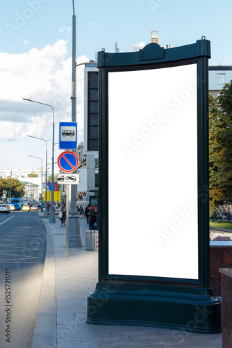 Long billboard in the city near the road. Blue sky with clouds, bus stop. Mock-up.