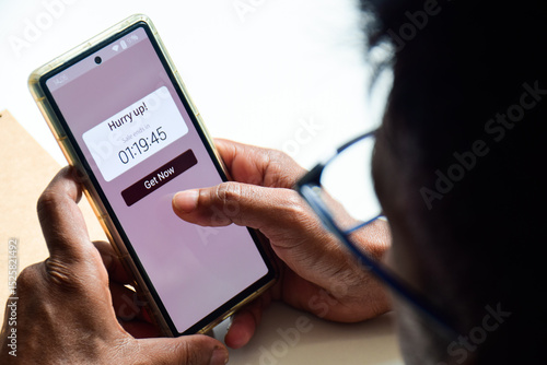 Man using phone displaying real-time notification about sales ending in a short time frame. FOMO Marketing strategy, online shopping concept.