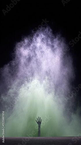 A hand reaching out from a smoky, ethereal landscape