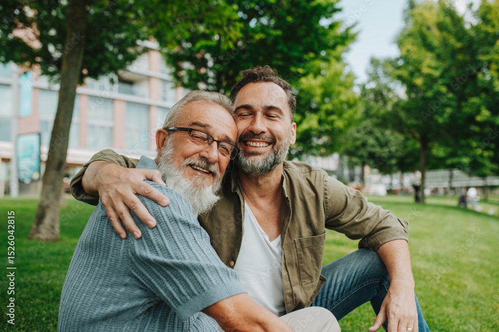 Fototapeta premium Portrait of handsome mature man and his older father hugging each other.