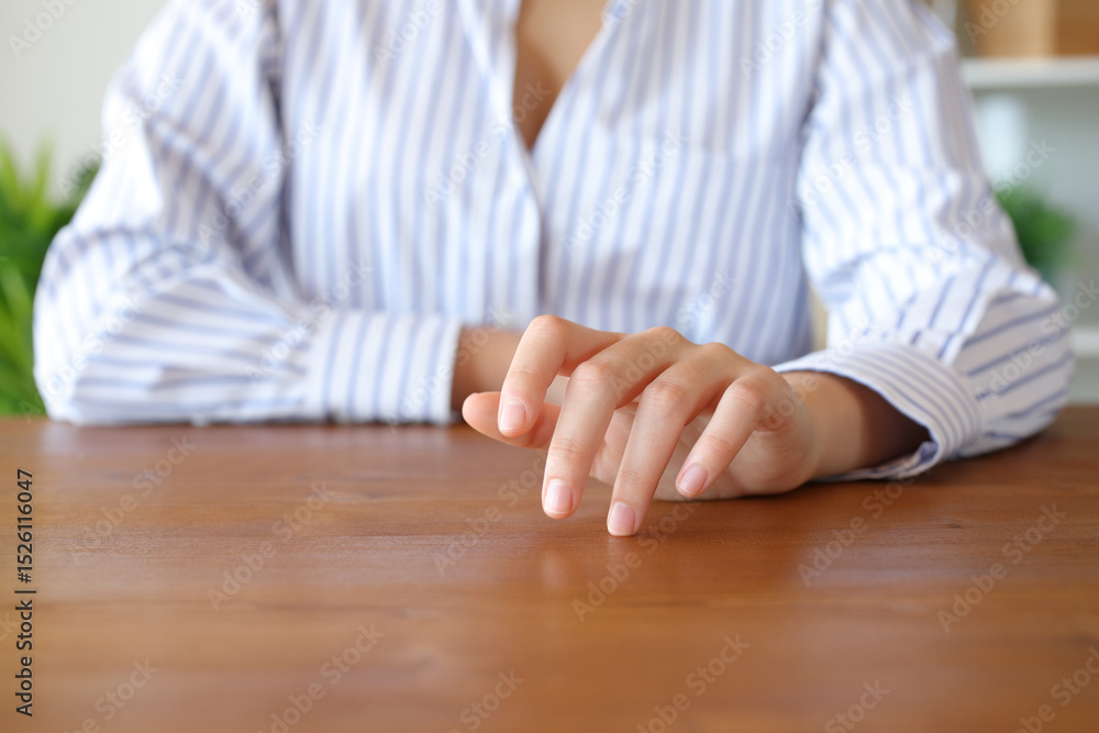 Fototapeta premium Woman hand waiting and tapping fingers on table