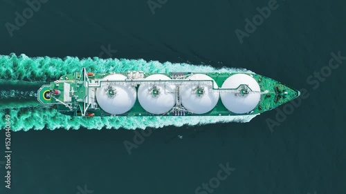 Aerial top view LNG Tanker ship (Liquified Natural Gas) with contrail in the ocean sea ship carrying container and running for export from container international port to custom ocean