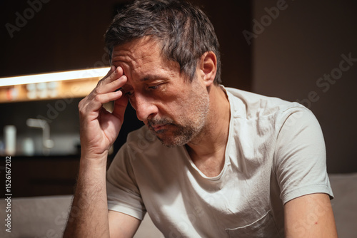 Tableau sur toile Failure and disappointment, low key portrait of mature adult male sulking