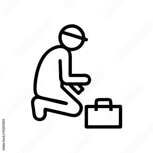Worker kneeling beside toolbox while preparing for a task  