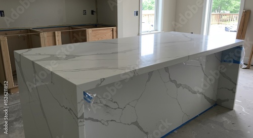 New Quartz Kitchen Island Countertop with Waterfall Edge in Home Under Construction. Modern Interior Design and Renovation Project.
