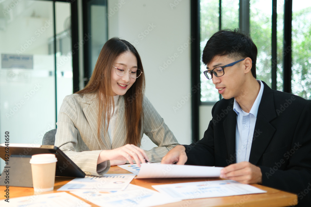 Two business people discuss financial strategy and collaborate with colleagues. Two business people discuss financial strategy and collaborate with colleagues.