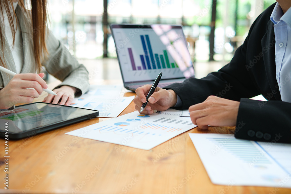 Two business people discuss financial strategy and collaborate with colleagues. Two business people discuss financial strategy and collaborate with colleagues.