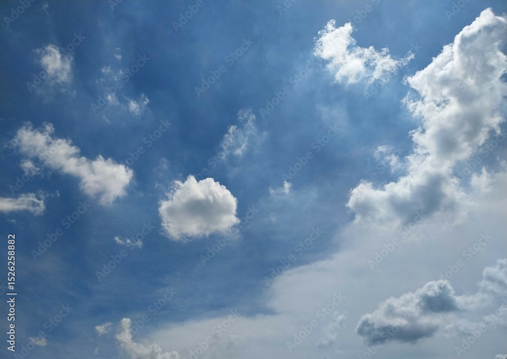 Obraz premium Fluffy Clouds Against Clear Azure