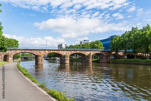 A old bridge spans a Saar river with a view of a city Saarbrucken Germany in the background