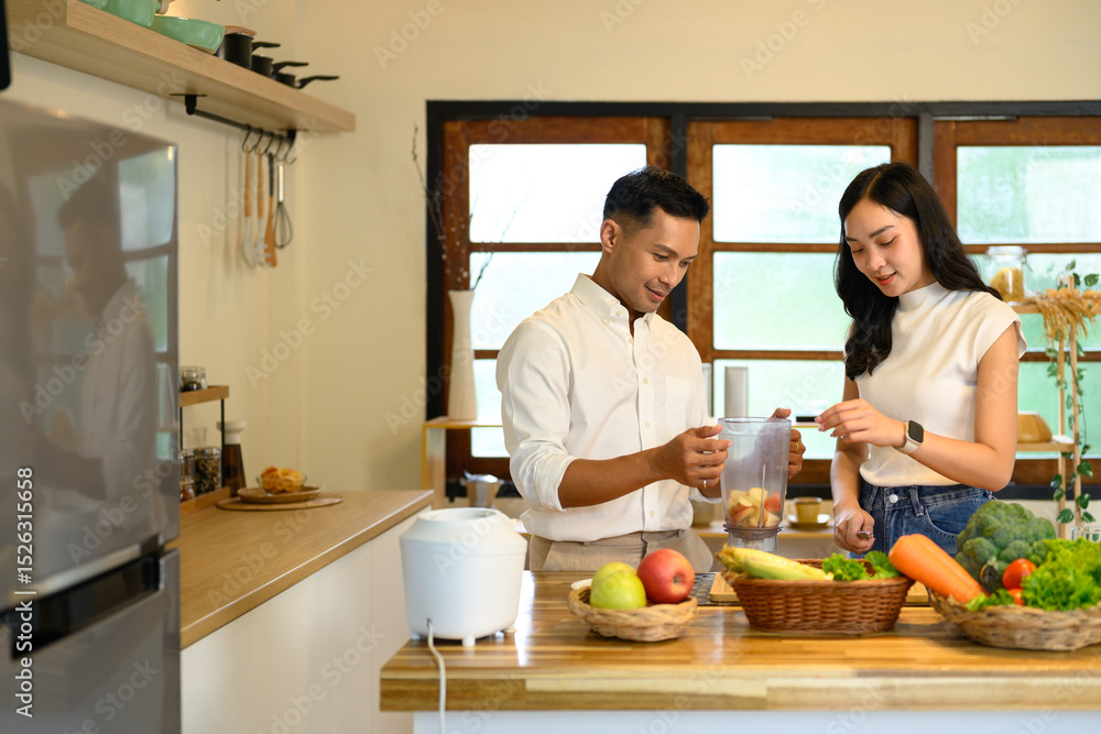 Young couple preparing a healthy smoothie together in a cozy home kitchen Young couple preparing a healthy smoothie together in a cozy home kitchen