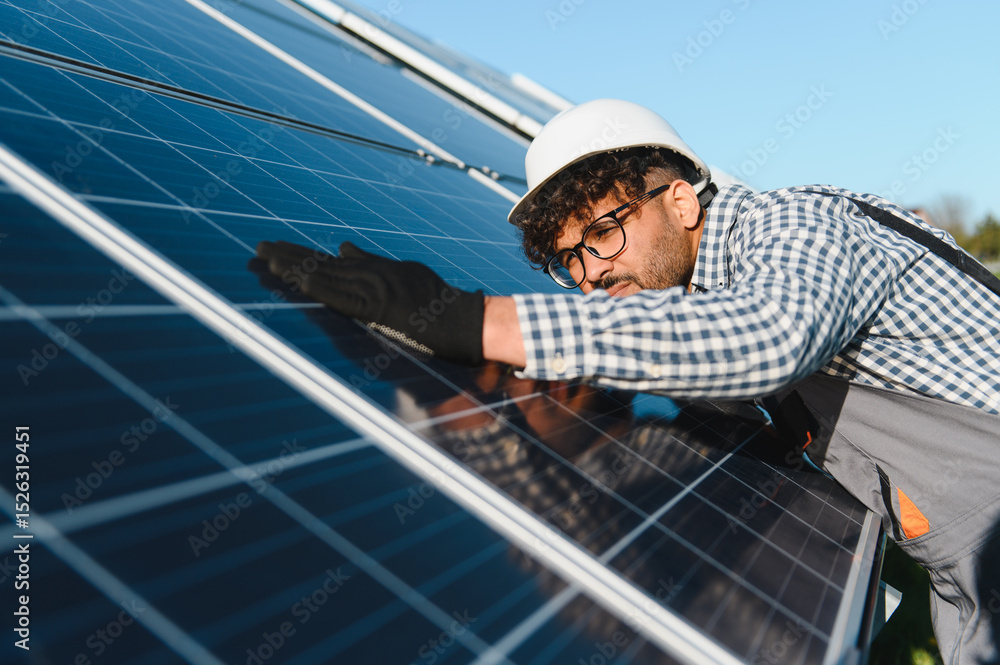 Engineer installing and checking solar panels in solar farm Engineer installing and checking solar panels in solar farm
